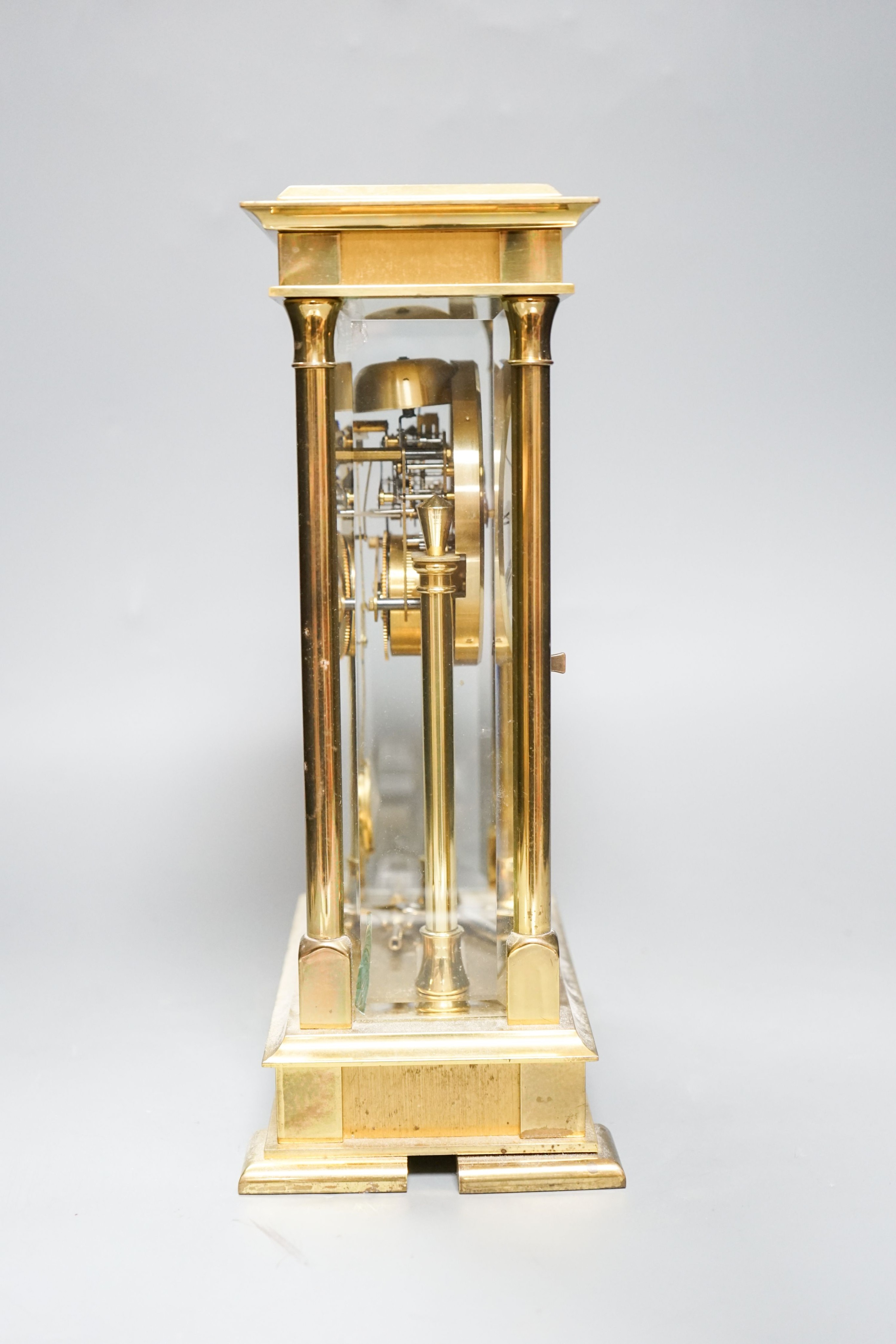 An 8 day brass cased clock 29cm